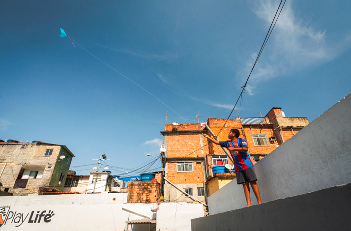 Colorful homes and winding streets in Vidigal, Rio de Janeiro, offering a glimpse into the vibrant favela community beneath a clear blue sky.