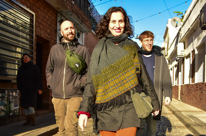 Anthropologist guides leading a group through a historic Buenos Aires street, sharing cultural insights and stories behind everyday life.