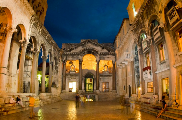 Illuminated ancient Roman ruins of Diocletian's Palace Peristyle at night in Split, Croatia.