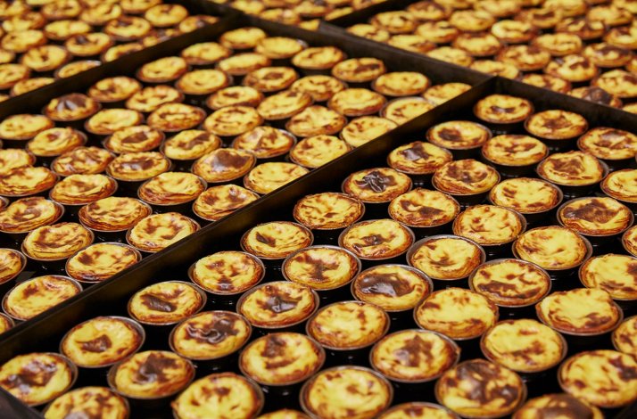 Bulk batch of Portuguese pastries served at Pastéis de Belém.