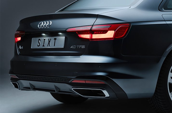 Rear view of an Audi A4 40 TFSI sedan bearing a 'SIXT' license plate, promoted as a Gold-status rental perk for Mastercard World Elite cardholders.