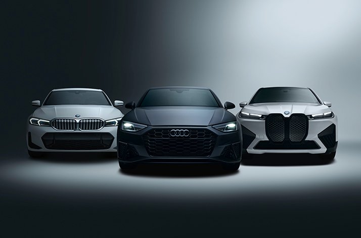 White BMW 5 Series, black Audi S5, and white BMW iX SUV facing forward in dramatic studio lighting, highlighting SIXT's Platinum-status vehicle selection.