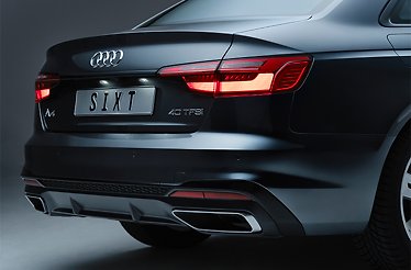 Rear view of an Audi A4 40 TFSI sedan bearing a 'SIXT' license plate, promoted as a Gold-status rental perk for Mastercard World Elite cardholders.