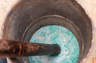 Crushed green glass inside a mortar used for making recycled beads at Cedi Bead Factory in Ghana.