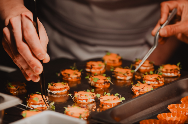 Close-up of chefs carefully preparing bite-sized dishes at Han's chef counter, showcasing the precision and craftsmanship behind a contemporary Korean tasting menu.