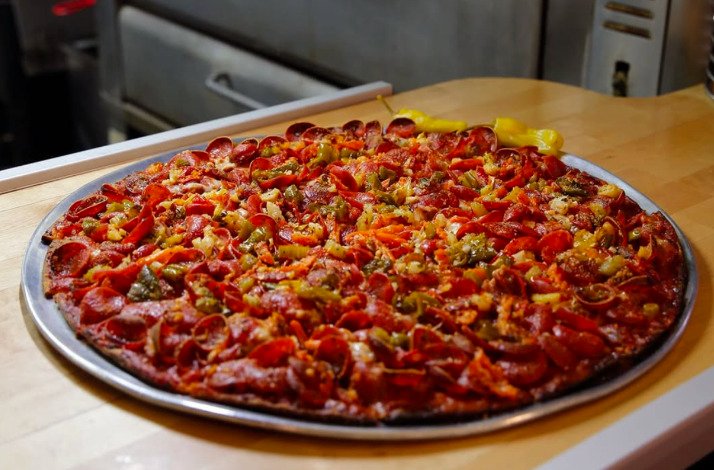 Chicago tavern-style thin-crust pizza on a tray at Novel Pizza Café.