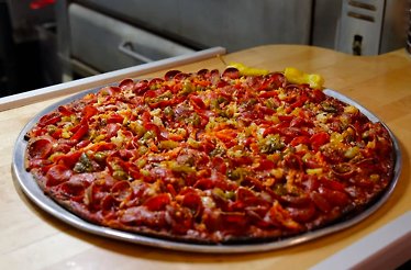 Chicago tavern-style thin-crust pizza on a tray at Novel Pizza Café.
