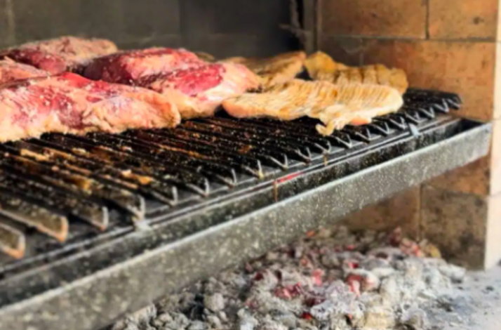 Traditional Argentine asado meats grilling over hot embers in Buenos Aires.