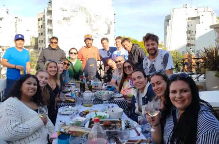 Guests gathering around a shared table during an authentic Argentine asado experience.