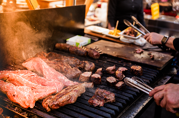 Traditional Argentine asado meats grilling over hot embers in Buenos Aires.