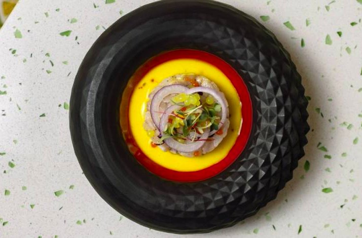 Ceviche at Hotel Lemongarden, Sutivan, Croatia, served in a textured black bowl over yellow sauce.