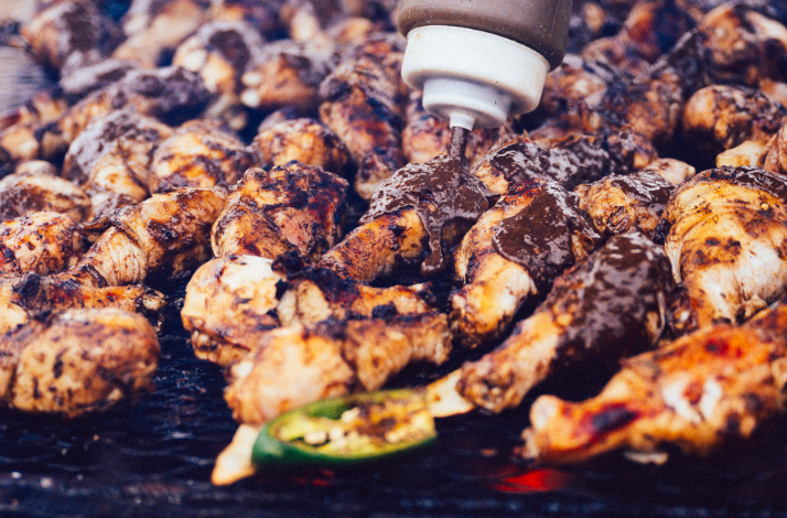 Sauce being poured on the grilled chicken at Austin Food and Wine Festival.