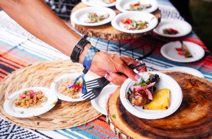 Foods being distributed on a small white plate at Austin Food and Wine Festival.