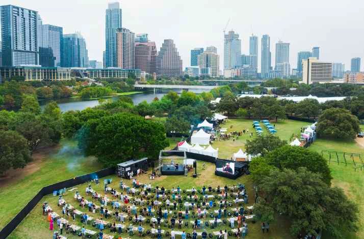 Aerial of Austin's skyline framing an upscale outdoor food festival.