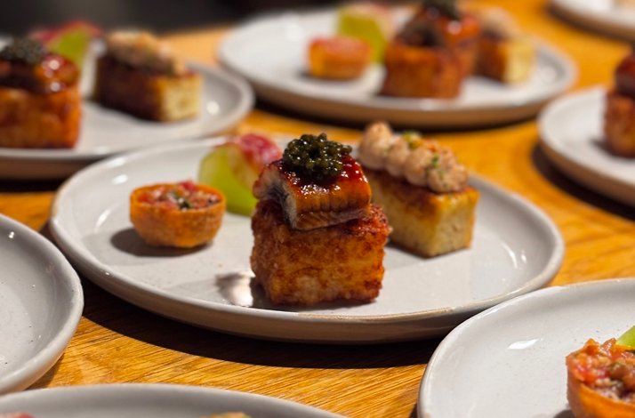 Zitz Sum tasting course service setup showing rows of artfully composed bites with caviar, glazed fish, and tartare.