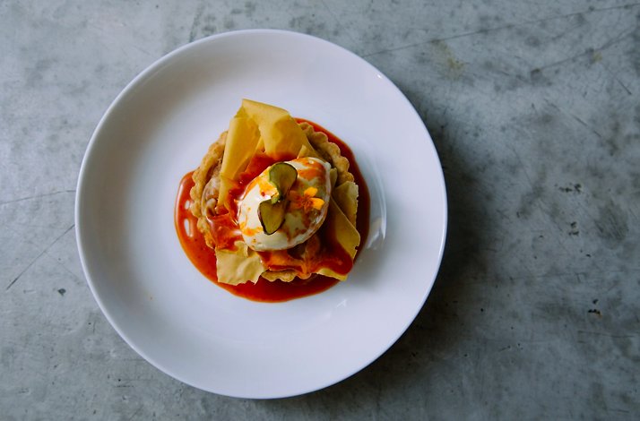 A savory tart served in a white bowl.