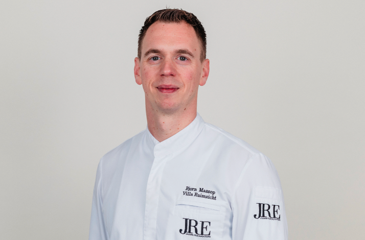 Chef Bjorn Massop wearing a white chef coat branded with JRE logo.