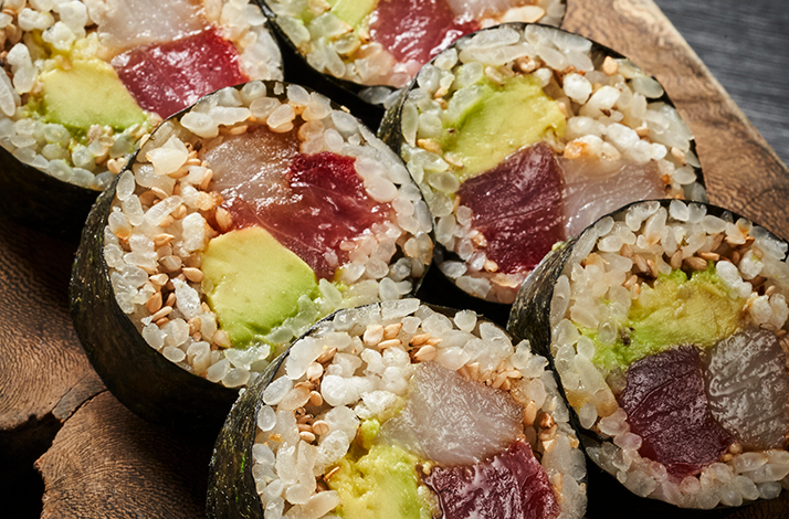 Handcrafted sushi rolls featuring fresh fish and local ingredients, prepared during an immersive culinary workshop led by expert chefs.