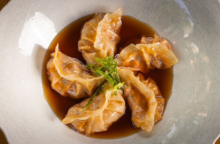 Gyoza meal served on a white plate. 