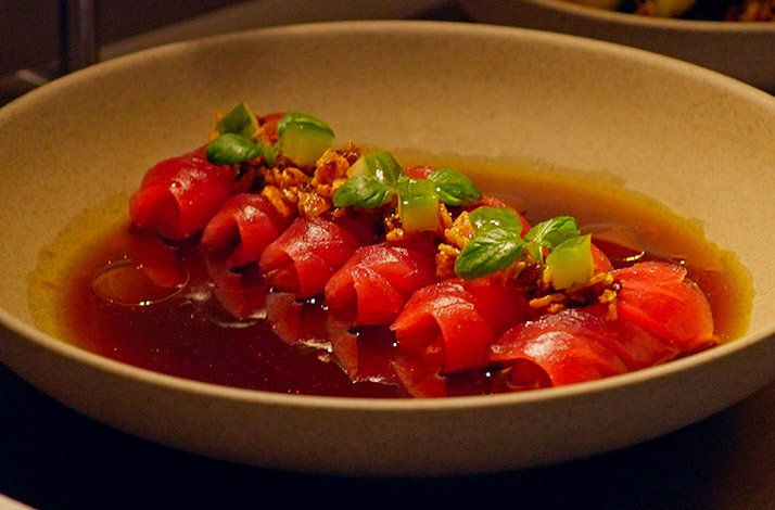 Tuna crudo rolls in savory ponzu broth with crisp toppings at Kokoro Hand Roll Bar, Dubai.