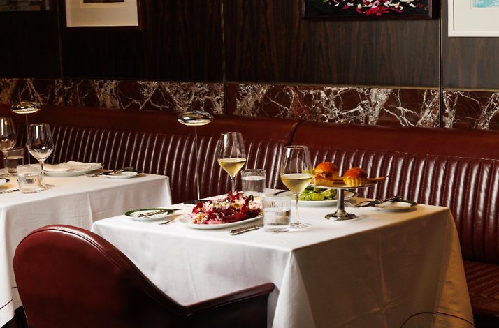 A table for two set with main dishes and appetizers.