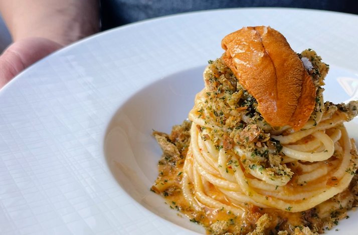 Twirled spaghetti topped with sea urchin, herbed breadcrumbs, and flaked sea salt at Osteria Giulia.