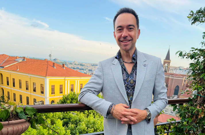 Kaan Sekban posing on a terrace overlooking Beyoğlu.