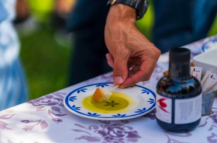 A guest dipping a piece of bread into local olive oil during a tasting at Hotel Vila Rova in Malinska, Croatia.