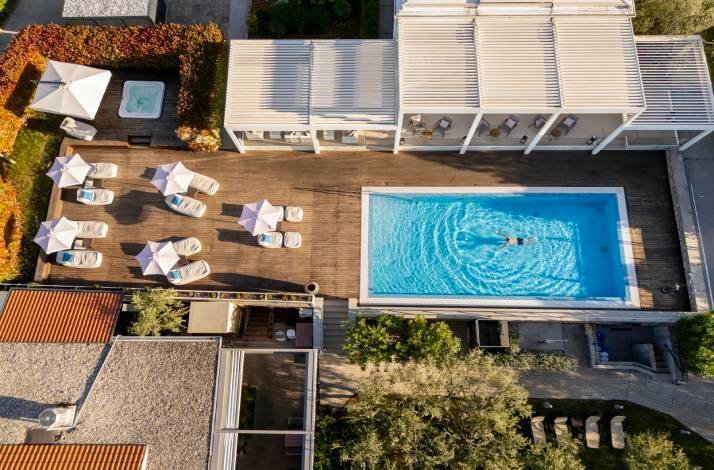 An outdoor swimming pool at Hotel Vila Rova in Malinska, Croatia, captured from above.