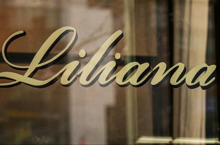 The name of Restaurant Liliana printed on glass .