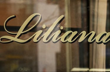 The name of Restaurant Liliana printed on glass .
